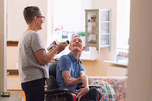 Support worker helping a participant in their home